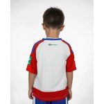 Primera equipación oficial del Granada CF para niños, temporada 2026-27. Conjunto de camiseta y pantalón rojiblancos.